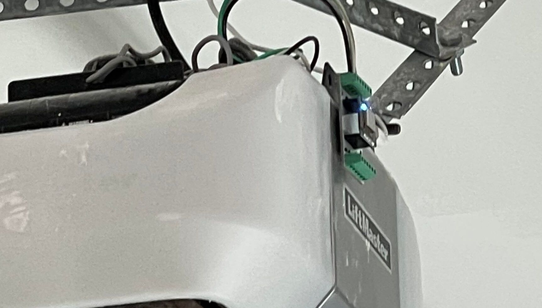 Photo of a LiftMaster garage door opener with an extension board attached to it.