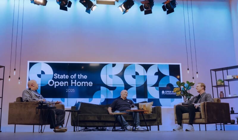 Three men sitting on sofas chatting on stage at the 2025 State of the Open Home event